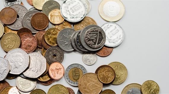 A mixture of different Coins, including a large number of copper coloured 1p's and 2p's spread acros