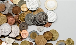 A mixture of different Coins, including a large number of copper coloured 1p's and 2p's spread acros